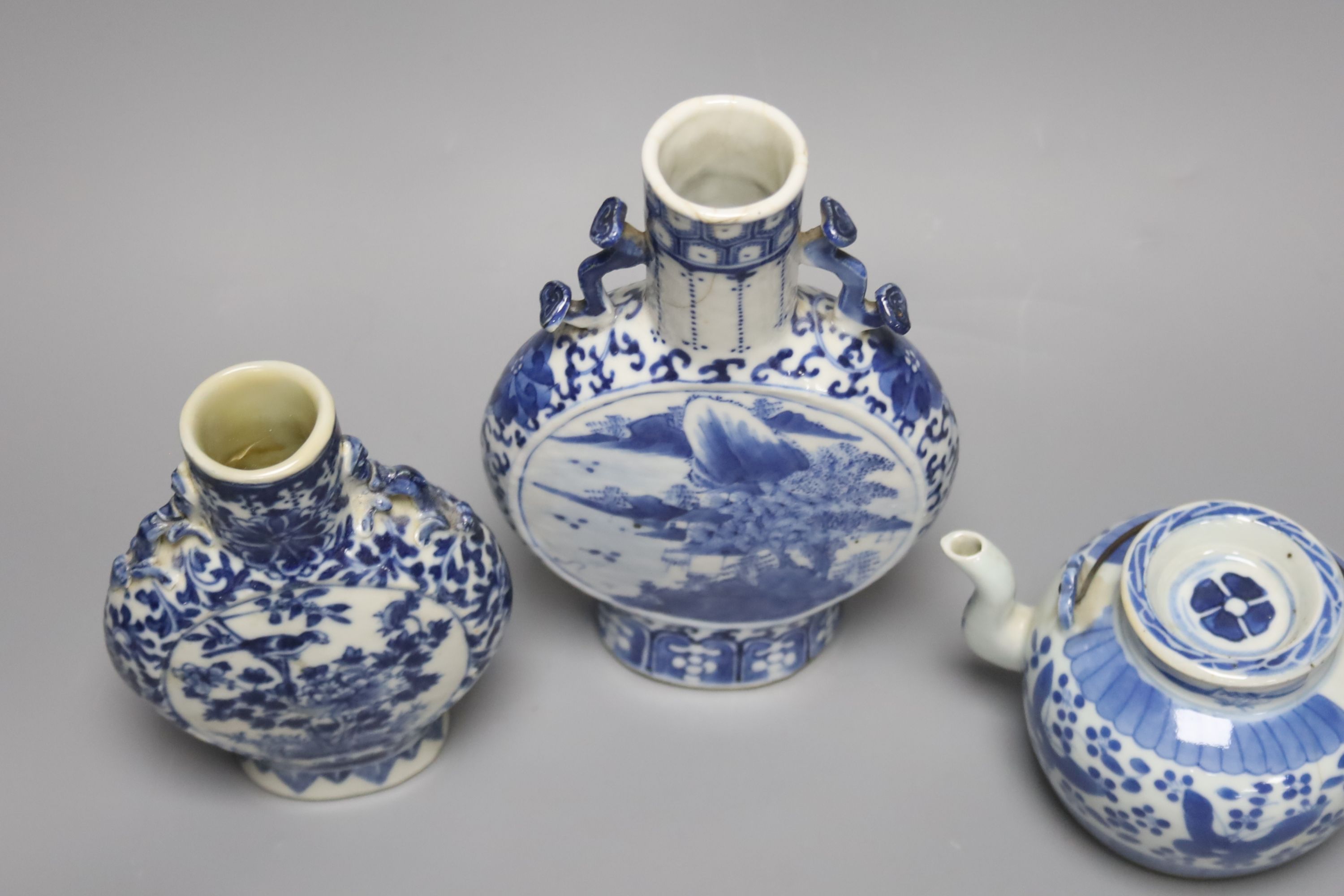 Two 19th century Chinese blue and white moon flasks and a teapot, tallest 21cm